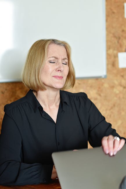 Woman taking a short, mindful break from work at her desk